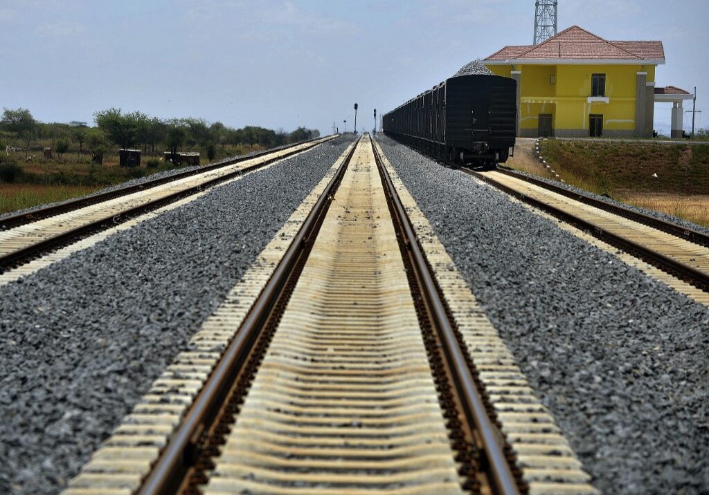 A cargo cars carrying ballast stands on the tracks at an bogie-exchange along a section of the new Standard Gauge Railway (SGR) near Voi some 332 kms southeast of Nairobi on March 17, 2016. About 60% of the 500 km SGR line, between the Kenyan capital and coastal town of Mombasa, is completed, have told Transport Ministry's officials and Kenya Railways Corporation adding that the railway line will be completed a year ahead of schedule. The SGR project is proposed to connect Mombasa to Malaba on the border with Uganda and continue onward to Kampala, Uganda's capital city. It will further run to Kigali in Rwanda with a branch line to Juba in South Sudan. (Photo by TONY KARUMBA / AFP)